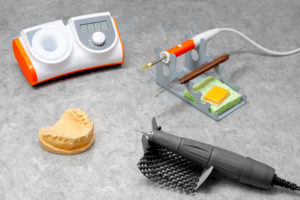 dentist orthopedist tools, workplace of dental orthopedist, scalpel, milling cutter, form, tooth matrix, denture laboratory